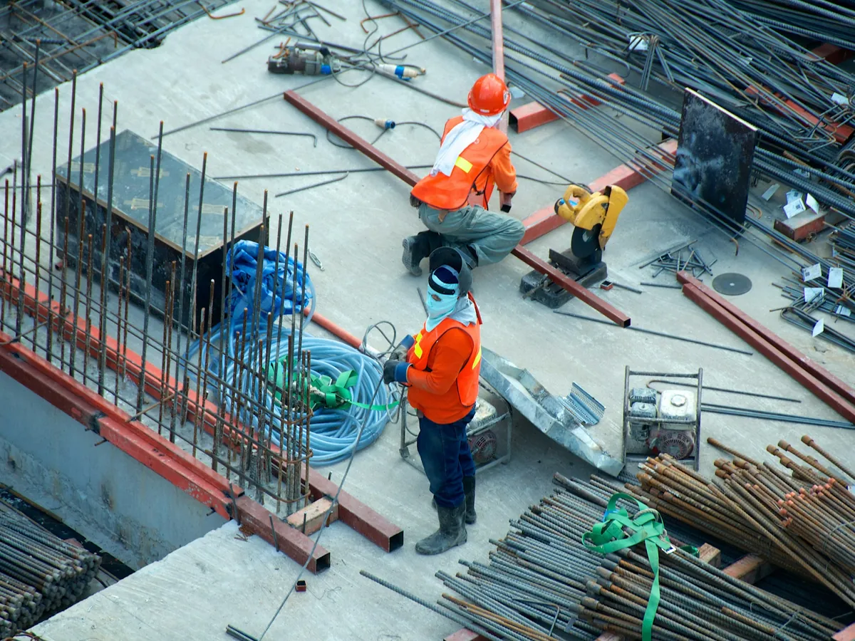 Workers placing reinforcement steel on a hospital slab